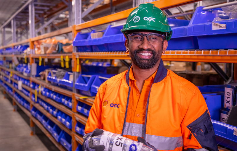 Employee stacking shelves in warehouse